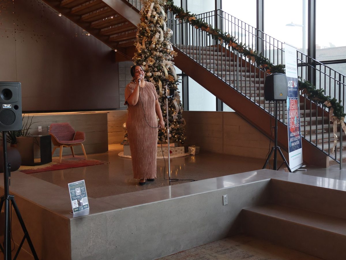 Performer on stage at a Venture Café Phoenix gathering